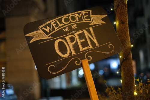 Signs come in we are open, a vintage image front of a restaurant.
