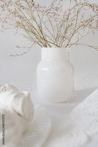 white vase with flowers on a white background