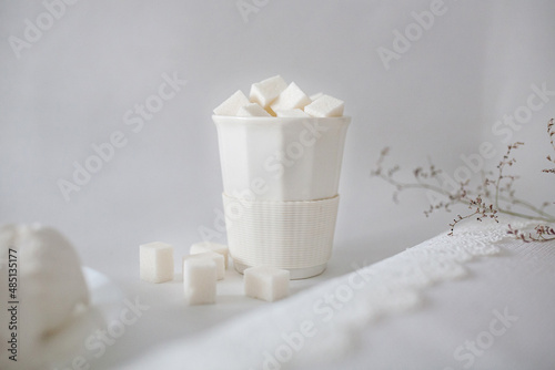 pieces of white sugar in a white glass