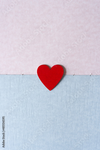 red heart on pink and blue parchment-like paper texture