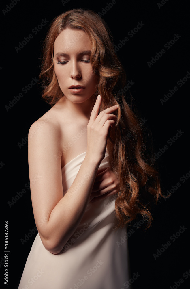 Dramatic portrait of lovely young sad girl against black background. Sorrowful woman among the dark Dramatic portrait of lovely young sad girl against black background. Sorrowful woman among the dark