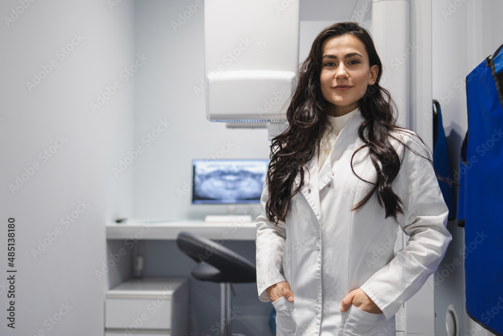 Portrait of female medic in CT scan room. Woman near the tomograph Portrait of female medic in CT scan room. Woman near the tomograph