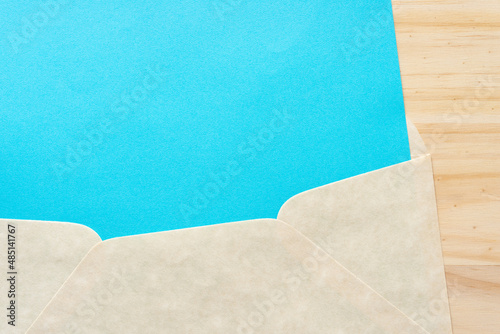 blue paper inside an envelope on a wooden surface