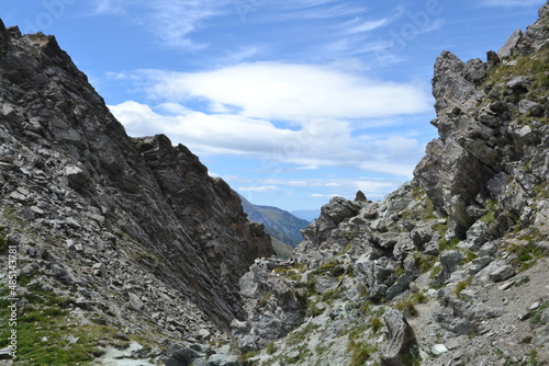 footpath through rocky mountains in the French alps in the region of Queyras on the French-Italian border in summer