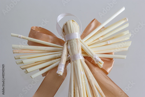 Tradition angels from handmade straw. National traditions of Ukraine.Christmas angel. Christmas straw ornament isolated on white background. Happy New Year and Merry Christmas card photo