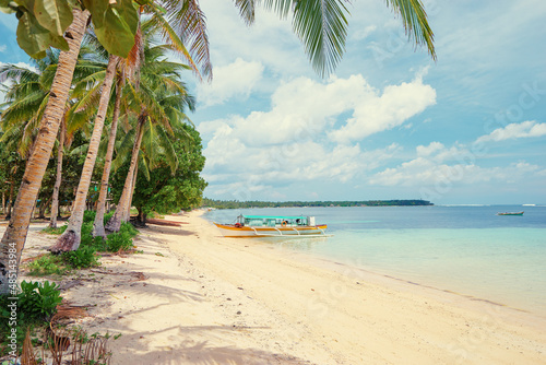 Fototapeta Naklejka Na Ścianę i Meble -  Beautiful landscape with tropical white sand beach with fishing boats. Siargao Island, Philippines.