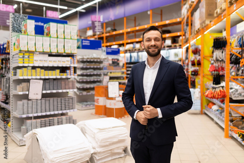 Fotografie half-length portrait of a hardware store owner with a smile on his face
