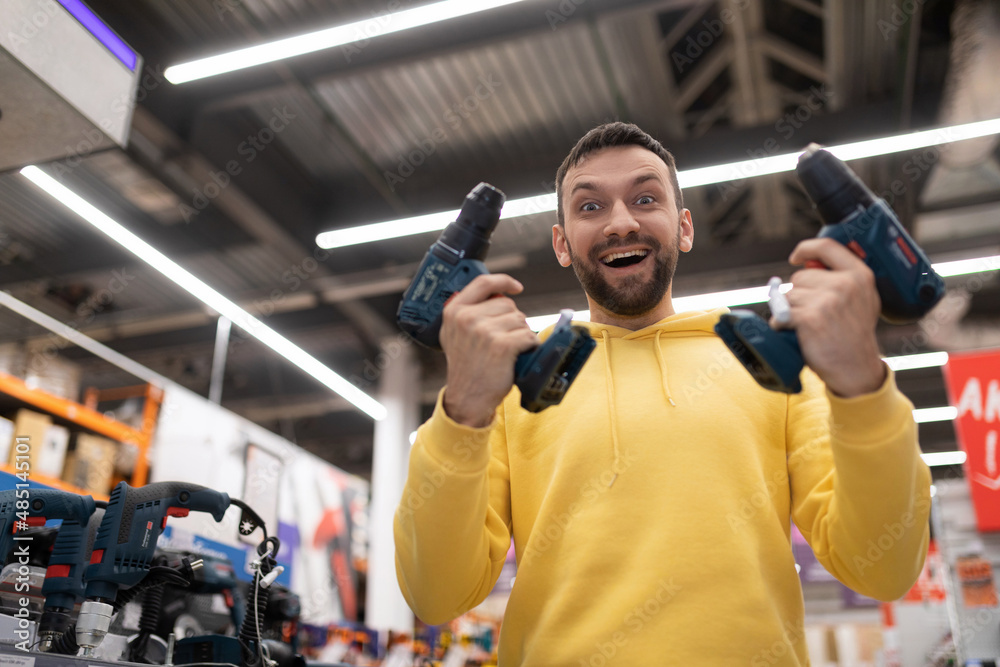 a satisfied customer bought two screwdrivers for a promotion in a construction hypermarket a satisfied customer bought two screwdrivers for a promotion in a construction hypermarket