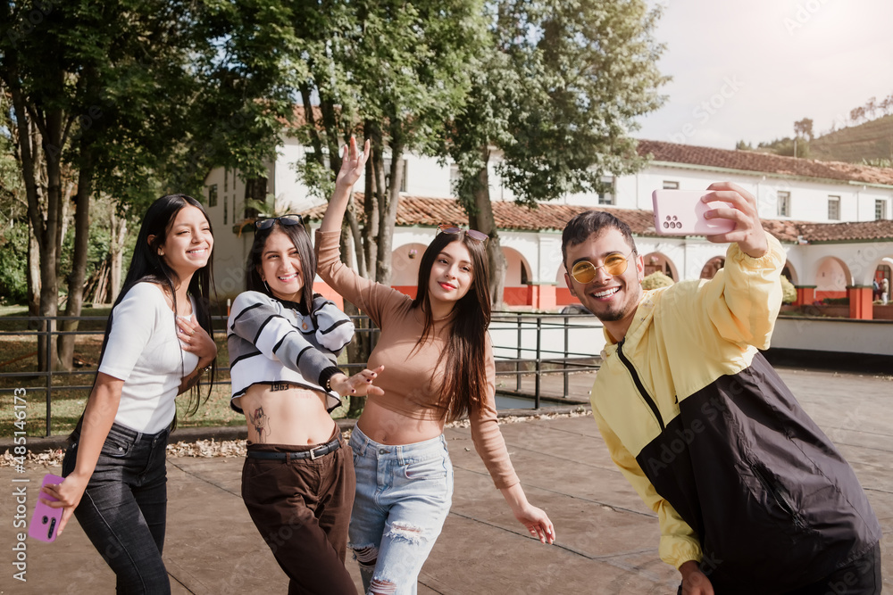 Group of happy and smiling friends taking a selfie on a sunny morning