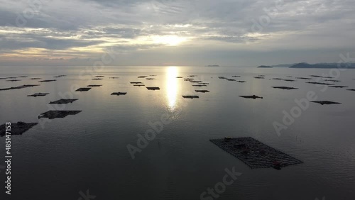 Aerial view kelong fish farm at sea in evening sunset photo