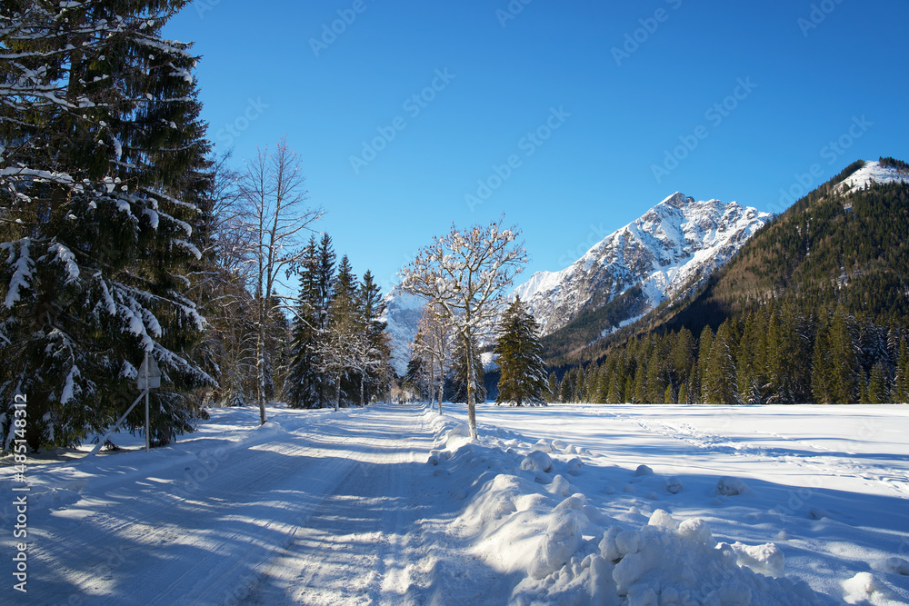 winter road through a snowy mountain landscape in Pertisau Austria