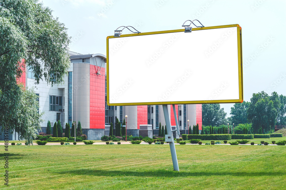 Mockup, billboard. Against the backdrop of a building in the city with green grass. Mockup, billboard. Against the backdrop of a building in the city with green grass.