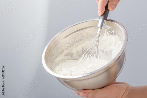 white whipped cream in metal bowl photo