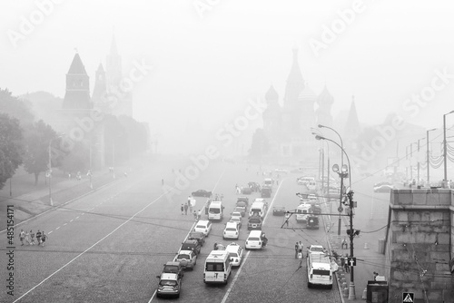 Moscow Kremlin and St Basil`s Cathedral in mist or haze, Russia. Black and white photo. photo