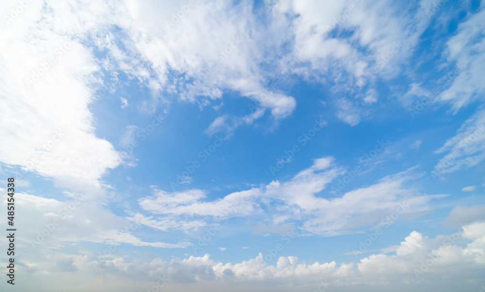 Clear blue sky with white fluffy clouds at noon. Day time. Abstract nature landscape background. Clear blue sky with white fluffy clouds at noon. Day time. Abstract nature landscape background.
