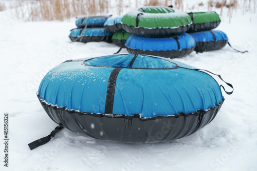 Winter entertainment tubing down the mountain. Tubing in the snow. Seasonal leisure.
