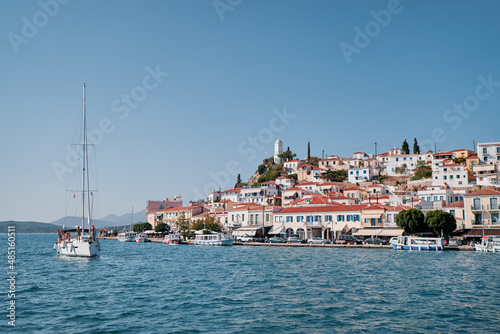 Scenic view of Poros island in a typical summer day. Old town with traditional white houses near the sea. Saronic gulf  Greece  Europe.