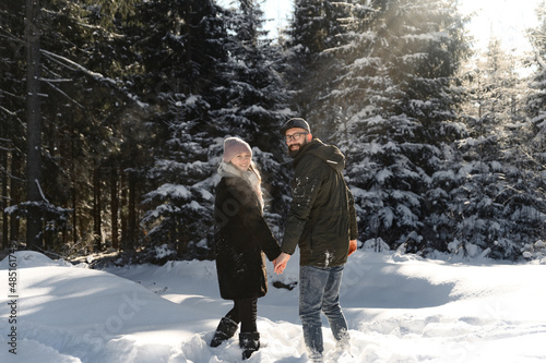 love and vacation concept - happy couple hugging and laughing outdoors in winter.couple in nature