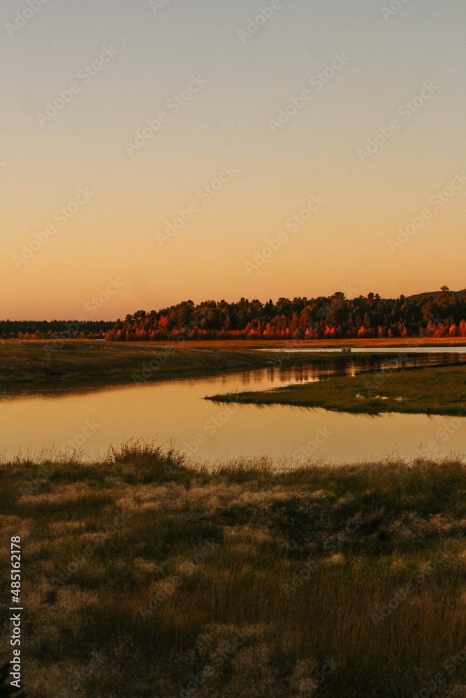 Naklejka premium sunset over the river
