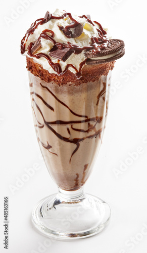 Milkshake garnished with whipped cream and chocolate