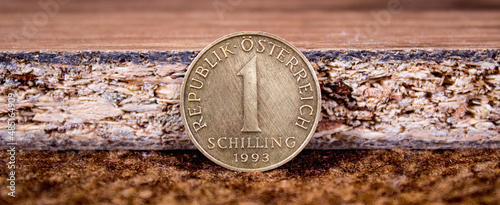 One Austrian shilling coin close up on retro background photo
