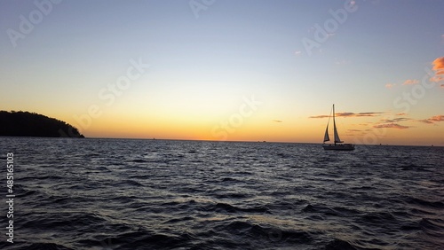 Sailboat sailing into sunset © Viconn
