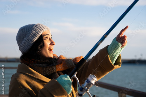 woman trying to fish with a fishing rod photo