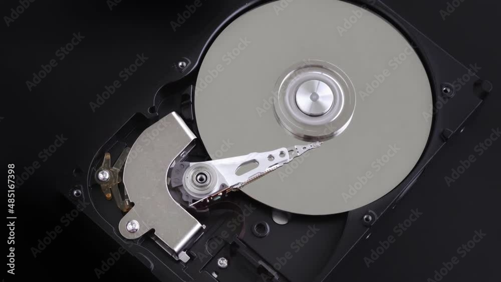 Hard disk drive inside with rotating platter and riding arm Hard disk drive inside with rotating platter and riding arm
