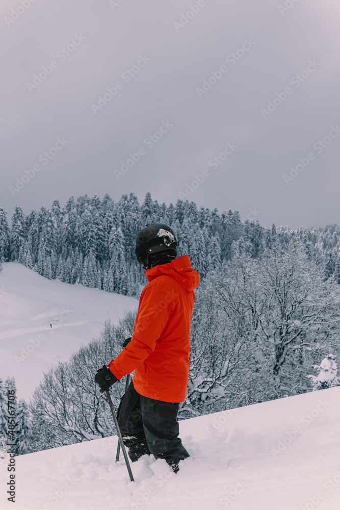 Young stylish Man On Ski Holiday In theMountains. Skier, skiing, winter sport - male skier.