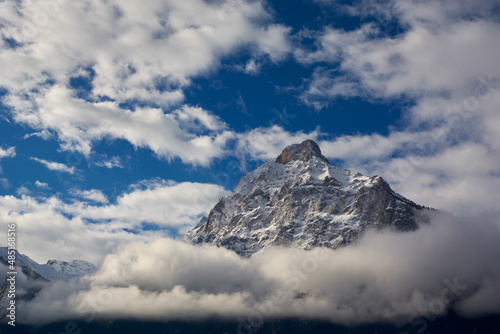 Mountains covered with snow and clouds on the shores of Lake Lucerne in Switzerland in winter. Switzerland, Fluelen.   photo