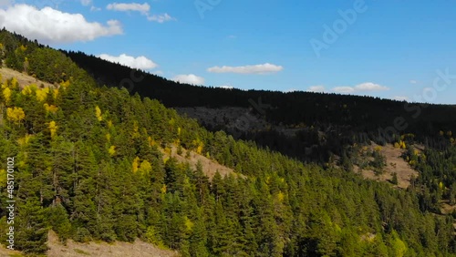 Autumn footage in the forests on the slopes of the mountains white clouds and blue sky in the background. The city of Bolu is in Turkey. drone video