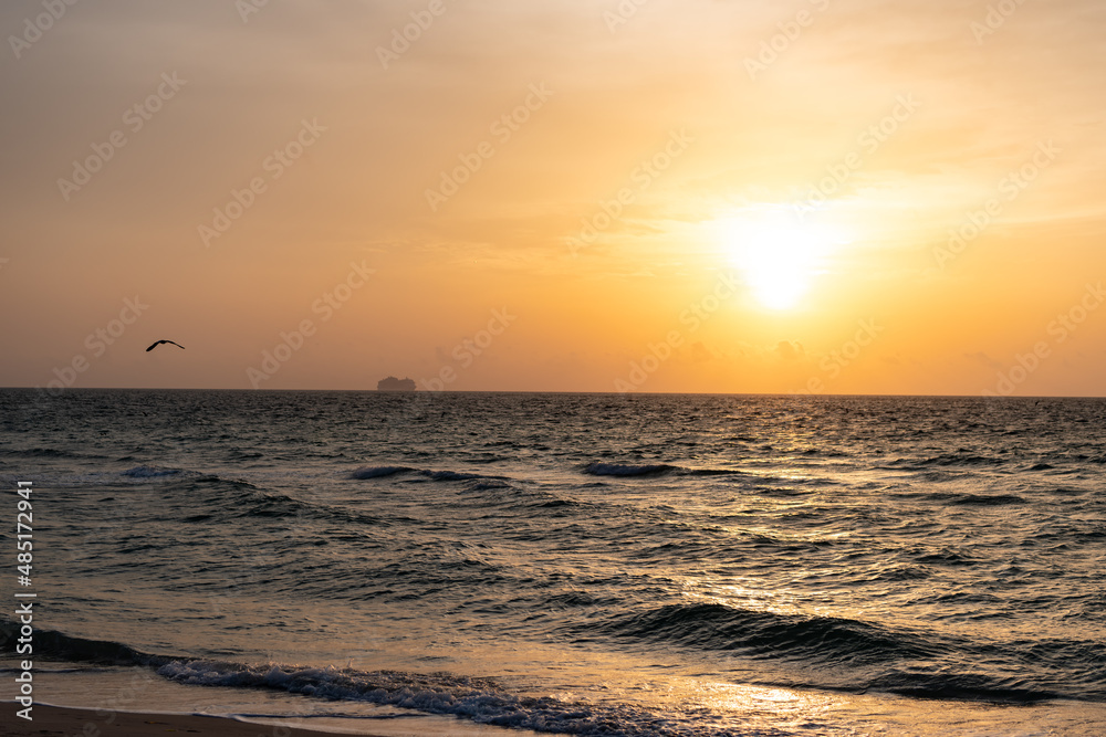 Seascape with sea waves rolling during sunset under evening sky