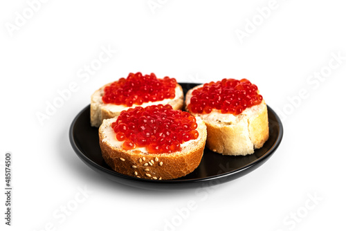 Red caviar isolated on a white background. Sandwiches with red caviar.