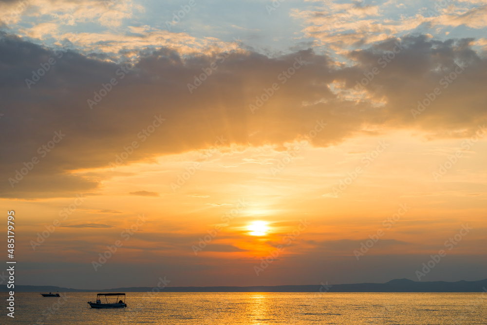 Naklejka premium Evening sky with dramatic clouds over the sea. Dramatic sunset over the sea.