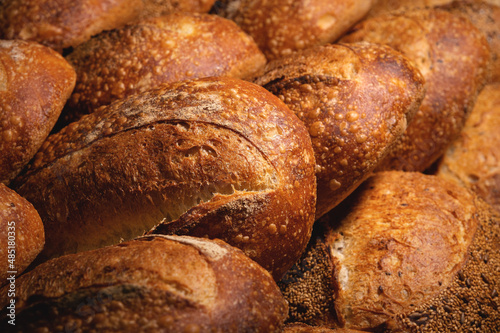 Fresh hot artisan bread in a white plastic transport box. Healthy and tasty food baked goods