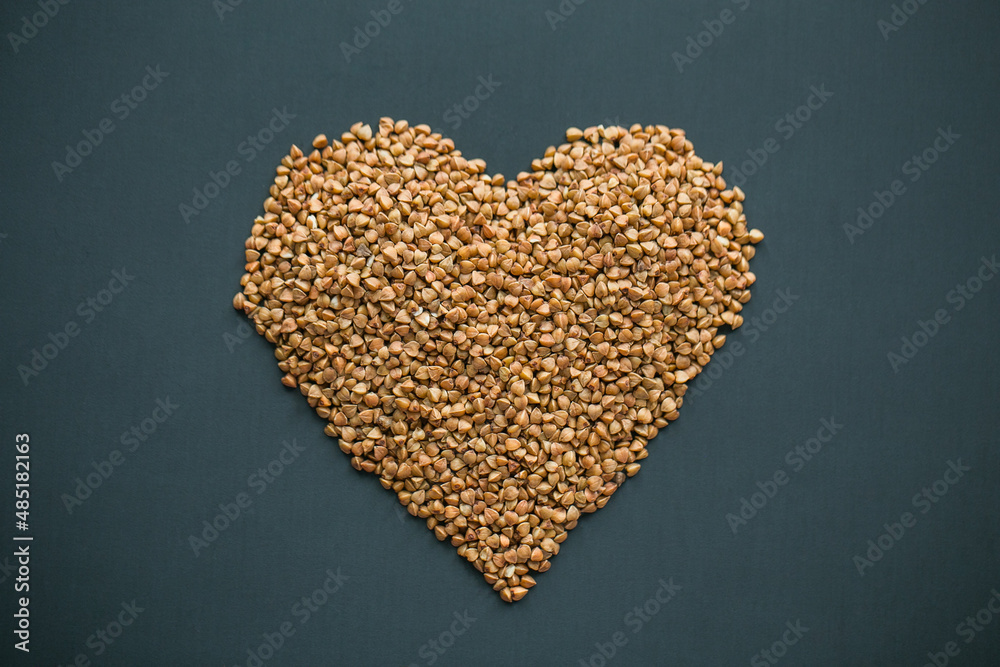 Buckwheat heart in the middle of dark gray background Buckwheat heart in the middle of dark gray background