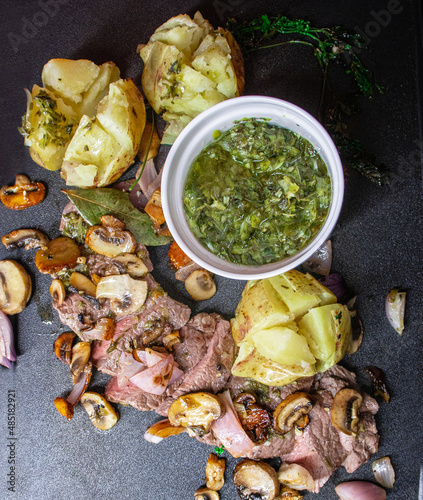 delicious meat grill with vegetables and chimichurri