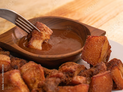 plate with chicharrones and BBQ sauce