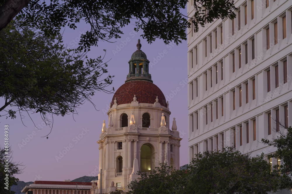 Image of the main tower of the Pasadena City Hall and a juxtaposed modern office building shown at dusk.