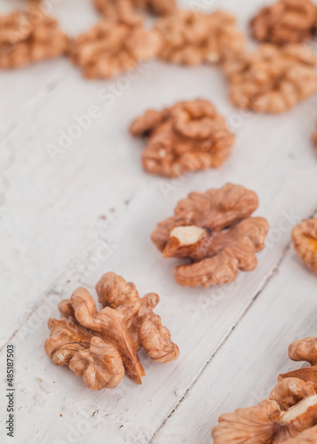 Fresh walnut kernels close up on a white wooden background. Organic food concept.