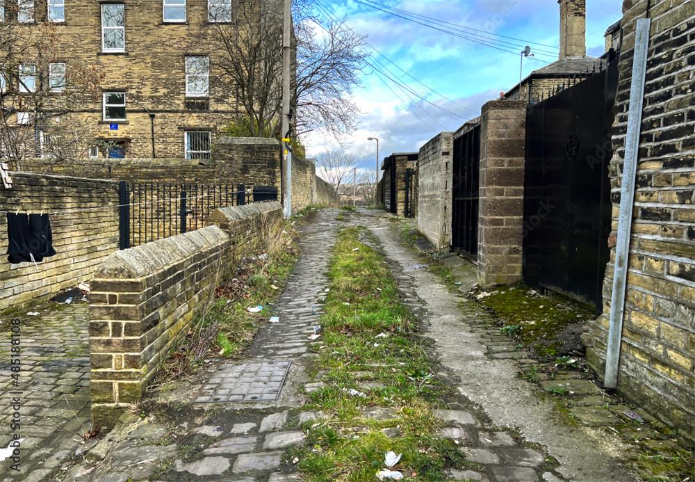 Victorian stone cobbled back street, with old stone built houses near, Lumb Lane, in the post industrial city of, Bradford, Yorkshire, UK