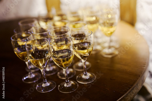 many glasses of champagne on a wooden table