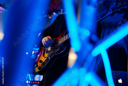Photography man playing guitar in a nightclub