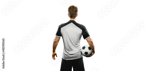 soccer player holding the ball with his back twisted. Isolated on the white background. photo