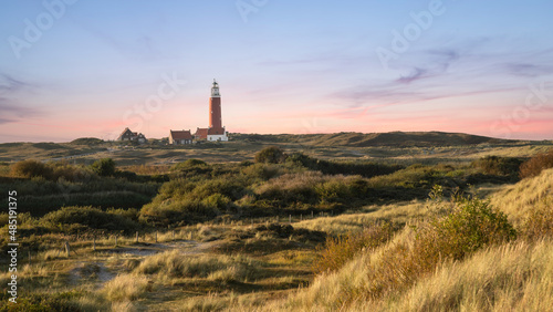 Dune landscape with a lighthouse on the Wadden Island of Texel, the Netherlands. photo