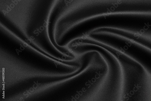 black artificial leather with waves and folds on PVC base