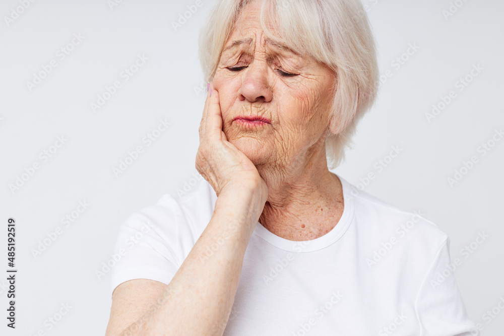 elderly woman holding his head discontent problem cropped view elderly woman holding his head discontent problem cropped view