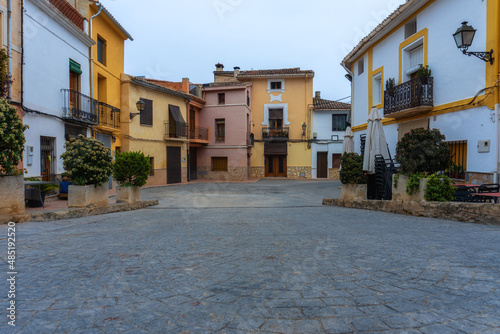 Town square, with cobbled ground and houses painted with striking colors in Carrícola (Valencia, Spain).