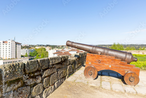 an antique cannon on a wooden chariot inside the castle wall with a view over Chaves city, district of Vila Real, Portugal