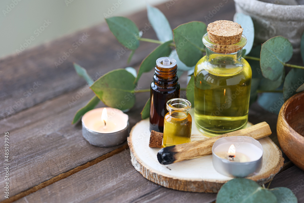 Assortment of natural oils in glass bottles on wooden background. Concept of pure organic ingredients in cosmetology. Bath accessories, atmosphere of harmony, relax. Close up macro. Healthy lifestyle Assortment of natural oils in glass bottles on wooden background. Concept of pure organic ingredients in cosmetology. Bath accessories, atmosphere of harmony, relax. Close up macro. Healthy lifestyle